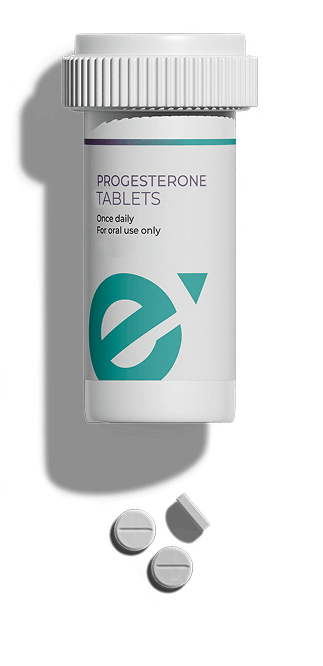 Two prescription bottles labeled Progesterone Tablets and Thyroid Capsules with tablets scattered beside them on a light background.