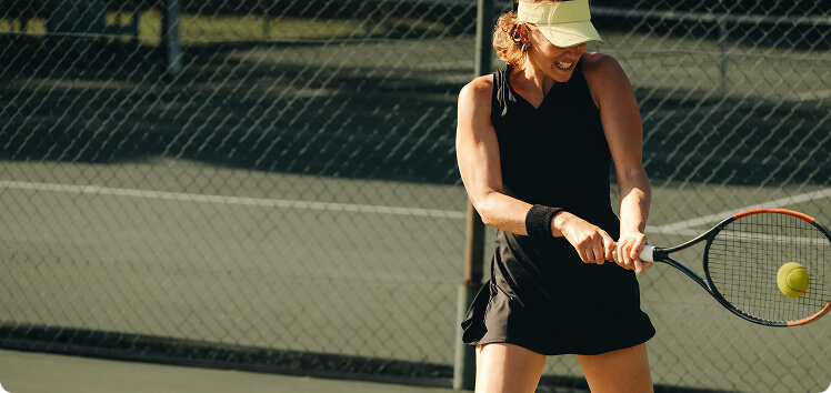 Woman sitting on a yoga mat with a glass of water nearby, representing how creatinine testing ensures kidney function and safe hormone therapy management.