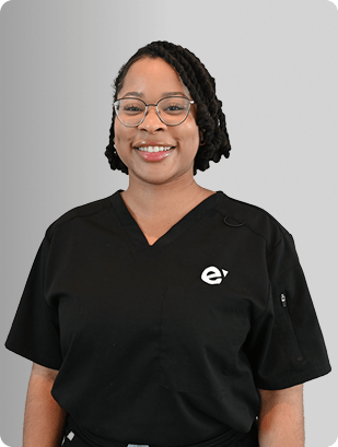 Kel Anyakee, MSN, APRN, FNP-BC, Nurse Practitioner at Fem Excel, smiling in black medical uniform.