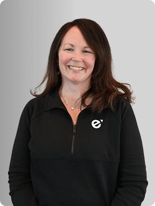 Karin Blais, FNP-C, Nurse Practitioner at Fem Excel, smiling in black zip-up uniform.