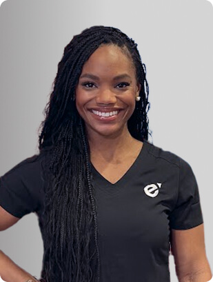 Jennifer Cesar, MSN, APRN, FNP-C, PMHNP-BC, Nurse Practitioner at Fem Excel, smiling in black medical uniform.