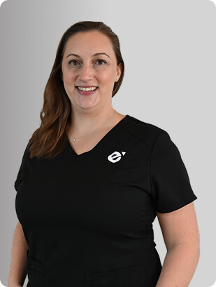 Ashley Fellows, FNP-C, Nurse Practitioner at Fem Excel, smiling in black medical uniform.