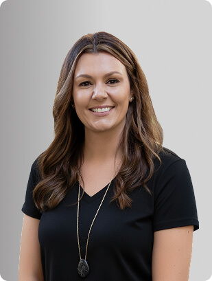 Kelly Donoho, MSN, APRN, FNP-BC, Nurse Practitioner at Fem Excel, smiling in black medical uniform.