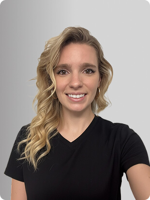 Lauren Duffy, DNP, APRN, FNP-C, Nurse Practitioner at Fem Excel, smiling in black medical uniform.