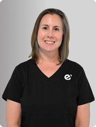 Angela Hillner, MSN, APRN, FNP-BC, Nurse Practitioner at Fem Excel, smiling in black medical uniform.