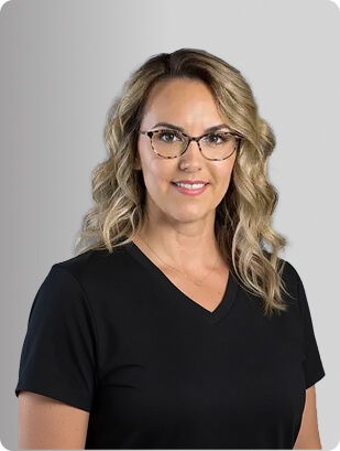 Frankie Kavan, APRN, FNP-C, Nurse Practitioner at Fem Excel, smiling in black medical uniform with glasses.