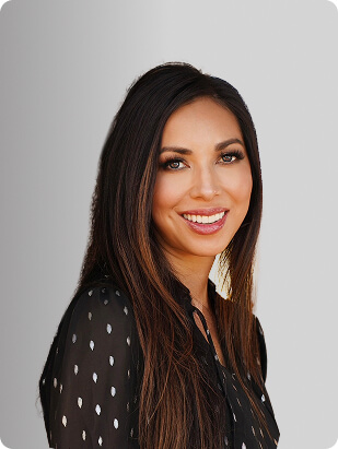 Tara Malone, FNP-BC, Nurse Practitioner at Fem Excel, smiling in black blouse with sheer sleeves.