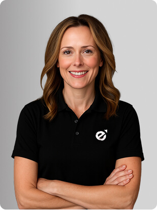 Paige McDonald, MSN, APRN, FNP-BC, Nurse Practitioner at Fem Excel, smiling in black polo with Fem Excel logo.