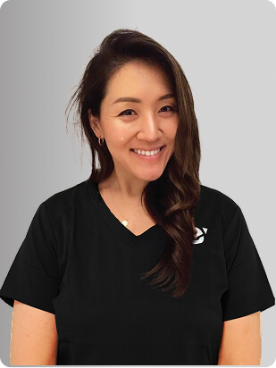 Jenny W. Song, MS, FNP-BC, Nurse Practitioner at Fem Excel, smiling in black medical uniform.