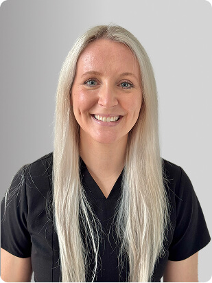Meaghan Reilly, MSN, APRN, FNP-C, Nurse Practitioner at Fem Excel, smiling in black medical uniform.