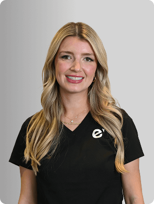 Angela Bucci, MSN, APRN, FNP-BC, Nurse Practitioner at Fem Excel, smiling in black medical uniform.