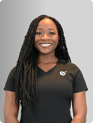 Happiness Chijioke, NP, Nurse Practitioner at Fem Excel, smiling in black medical uniform.