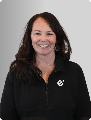 Karin Blais, FNP-C, Nurse Practitioner at Fem Excel, smiling in black zip-up uniform.