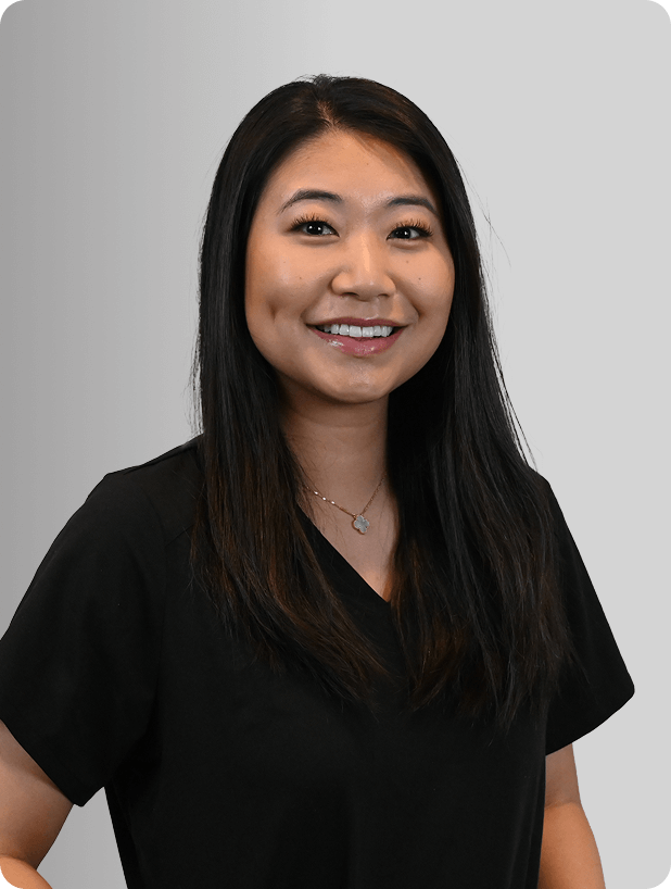 Agnes Choo, MSN, APRN, FNP-C, Nurse Practitioner at Fem Excel, smiling in black medical uniform.