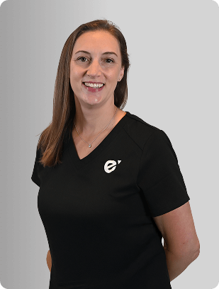 Ashley Fellows, FNP-C, Nurse Practitioner at Fem Excel, smiling in black medical uniform.