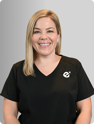 Meagan Gregory, MSN, APRN, FNP-C, Nurse Practitioner at Fem Excel, smiling in black medical uniform with glasses.