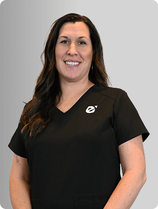 Michelle Hass-Roe, MSA, APRN, CNP, Nurse Practitioner at Fem Excel, smiling in black medical uniform.