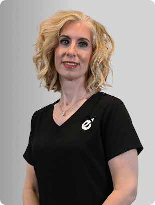 Reagan Walls, FNP-C, Nurse Practitioner at Fem Excel, smiling in black medical uniform.