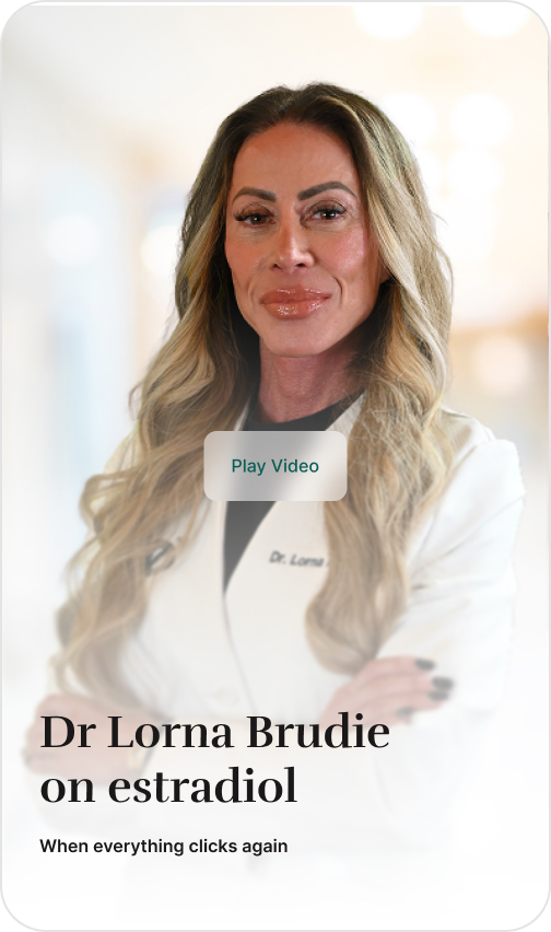 Dr. Lorna, a woman with long blonde hair, posing in a white lab coat with her arms crossed.