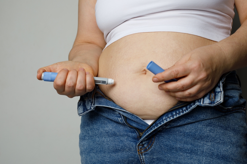 Woman injecting Semaglutide into her stomach