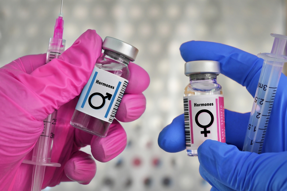 vials of testosterone male and estrogen female hormones for treatment hormone therapy injections concept