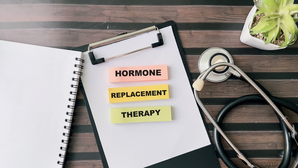 Concept of Hormone Replacement Therapy written on sticky notes isolated on wooden table